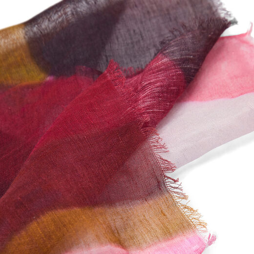 The detail of a multicoloured scarf with an abstract pattern.