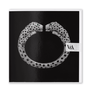 A square black greetings card featuring an iconic Cartier bangle design; two diamond-studded panthers facing each other
